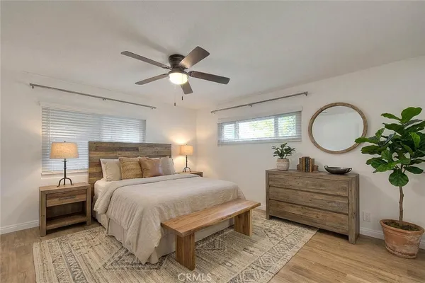 a bedroom with a bed chandelier and a mirror