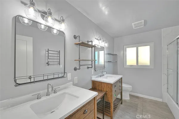 a bathroom with a sink double vanity and a mirror