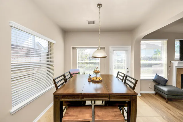 a view of a dining room with furniture and window