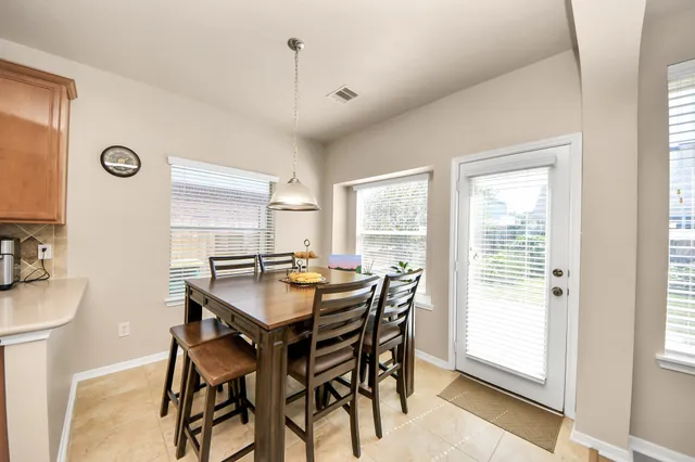 a dining room with furniture and window