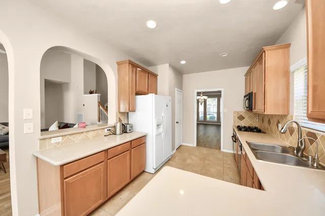 a spacious bathroom with a double vanity sink a mirror and a bathtub