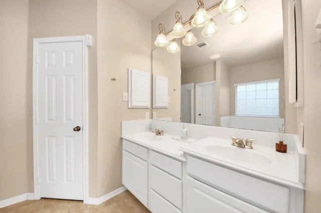 a bathroom with a sink a vanity and a mirror