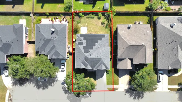 an aerial view of residential houses with outdoor space and street view