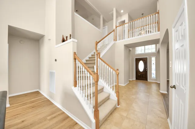 a view of entryway and hall with wooden floor