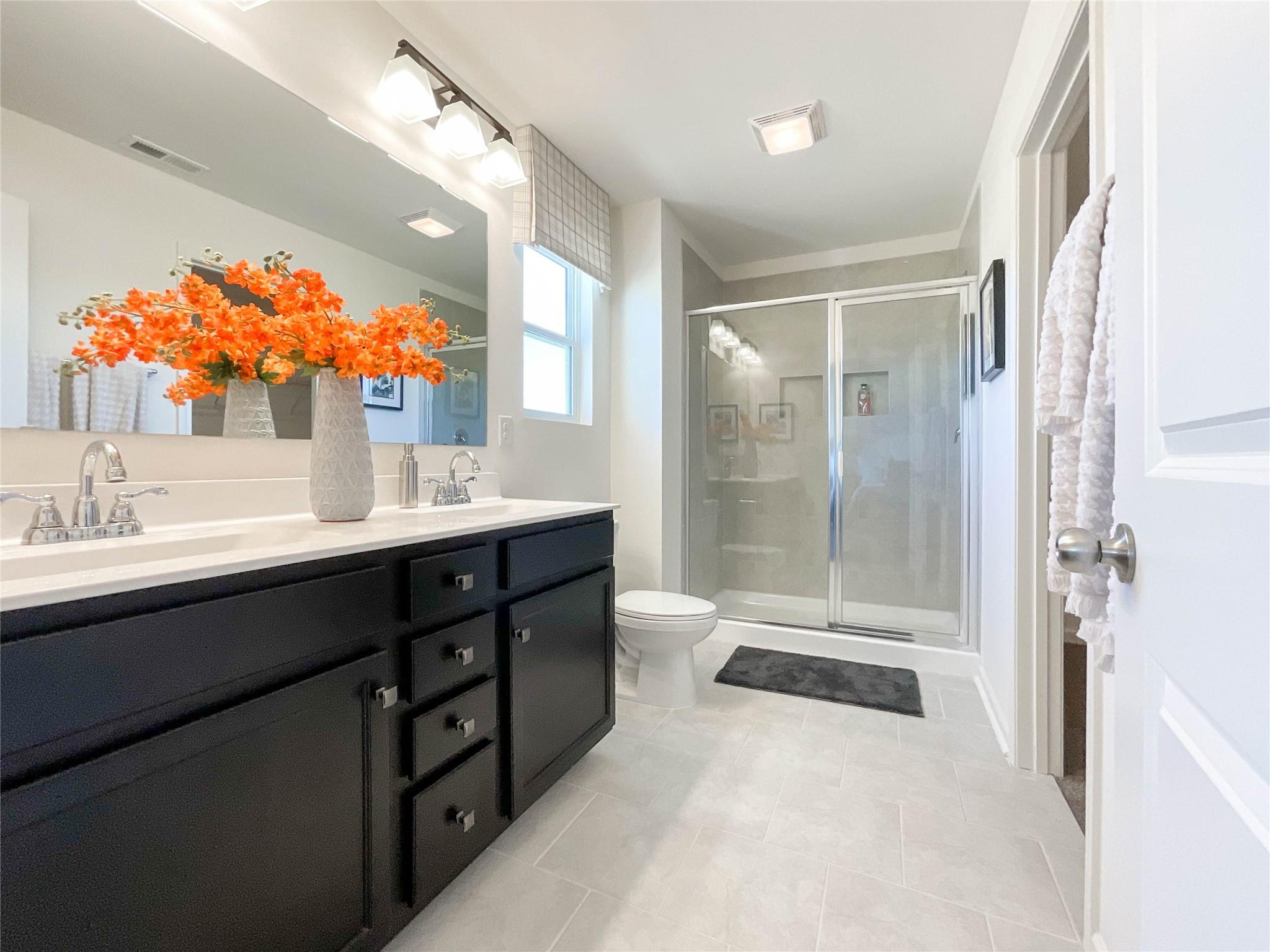 717 Alexander Commons Drive Monroe, NC 28112 - Photo 25 of 33 a bathroom with a double vanity sink mirror and shower