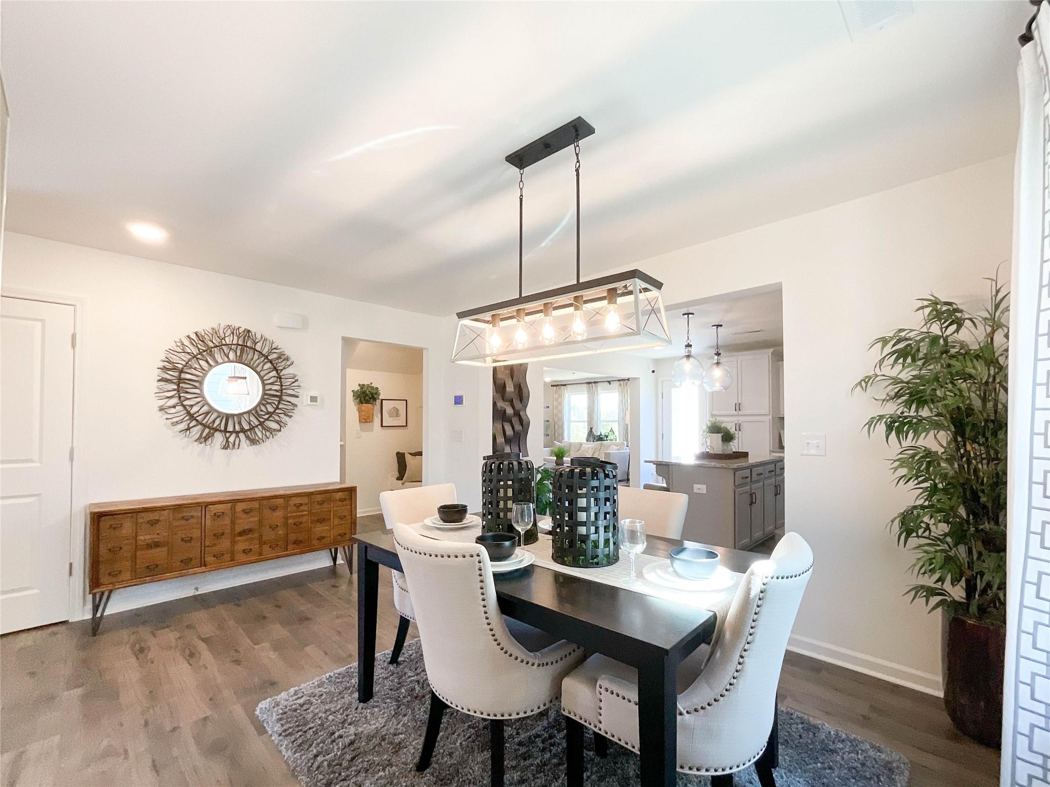 717 Alexander Commons Drive Monroe, NC 28112 - Photo 6 of 33 a view of a dining room with furniture and wooden floor