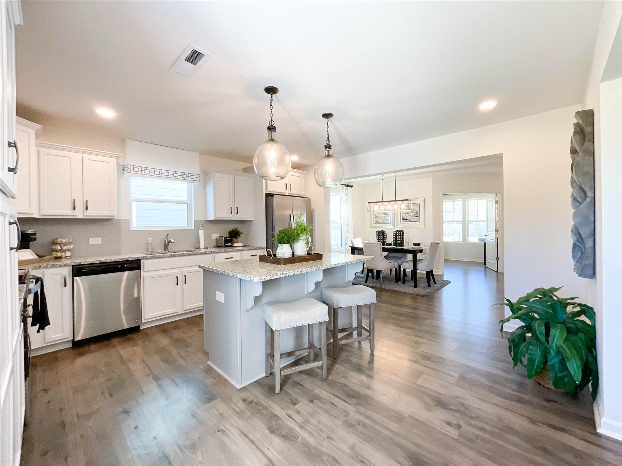 717 Alexander Commons Drive Monroe, NC 28112 - Photo 10 of 33 a large white kitchen with lots of counter space a sink and appliances