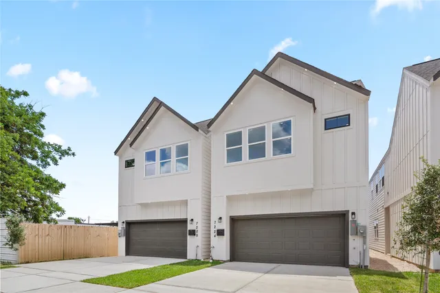 a front view of house with yard and trees