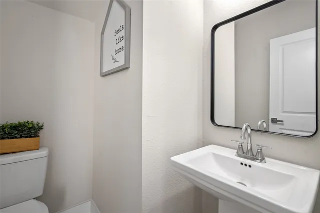 a view of a hallway with wooden floor and closet area