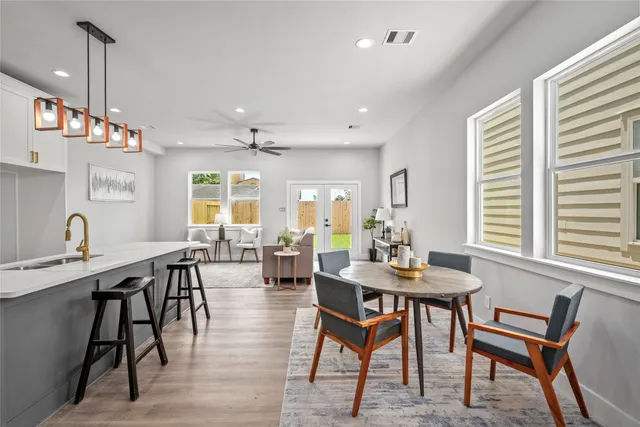 a view of a a dining room with furniture window and wooden floor