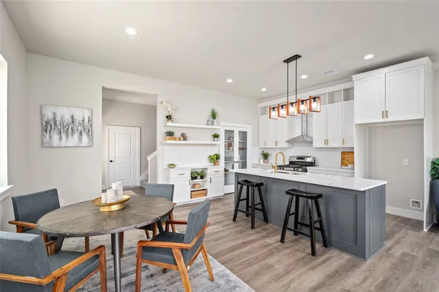 a kitchen that has a table and chairs in it