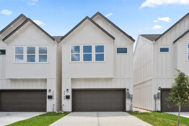 a front view of a house with a garden and garage