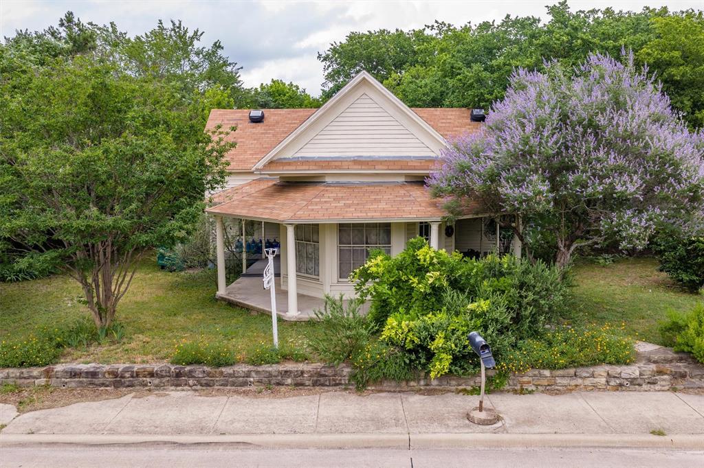 1007 West Belt Line Road Cedar Hill, TX 75104 - Photo 18 of 30 Gable-front home featuring a covered wraparound porch, horizontal siding, and a gabled roof