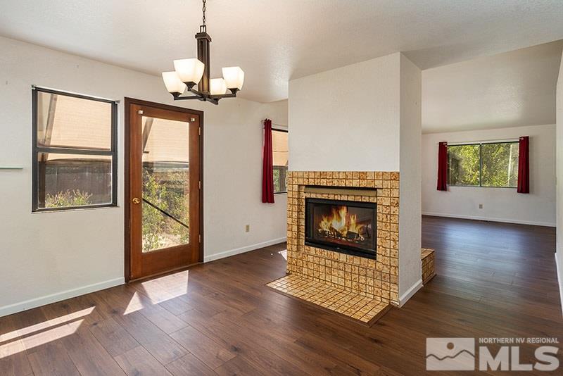 1420 Clough Road Reno, NV 89509 - Photo 4 of 25 a view of an empty room with wooden floor fireplace and a window