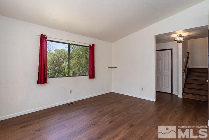 1420 Clough Road Reno, NV 89509 - Photo 5 of 25 a view of an empty room with wooden floor and a window
