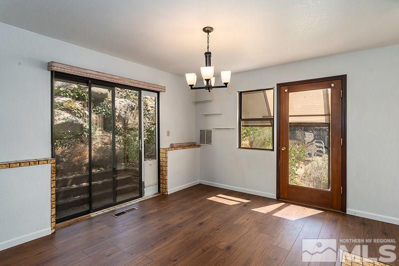 1420 Clough Road Reno, NV 89509 - Photo 7 of 25 an empty room with wooden floor and windows