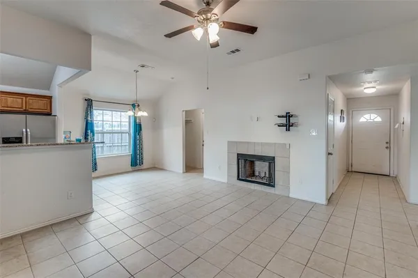 a view of an empty room and fire place