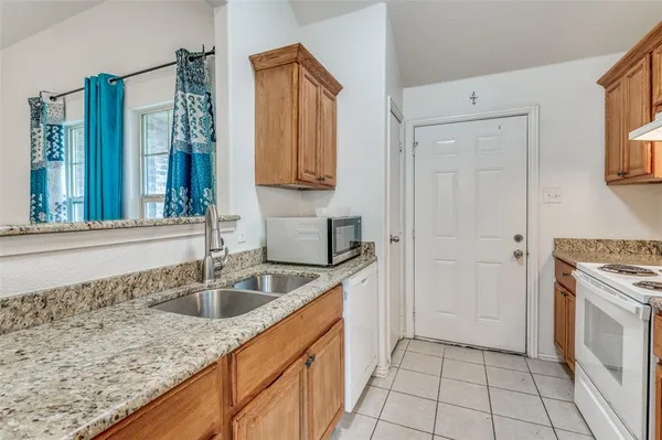 a kitchen with a sink stove and cabinets