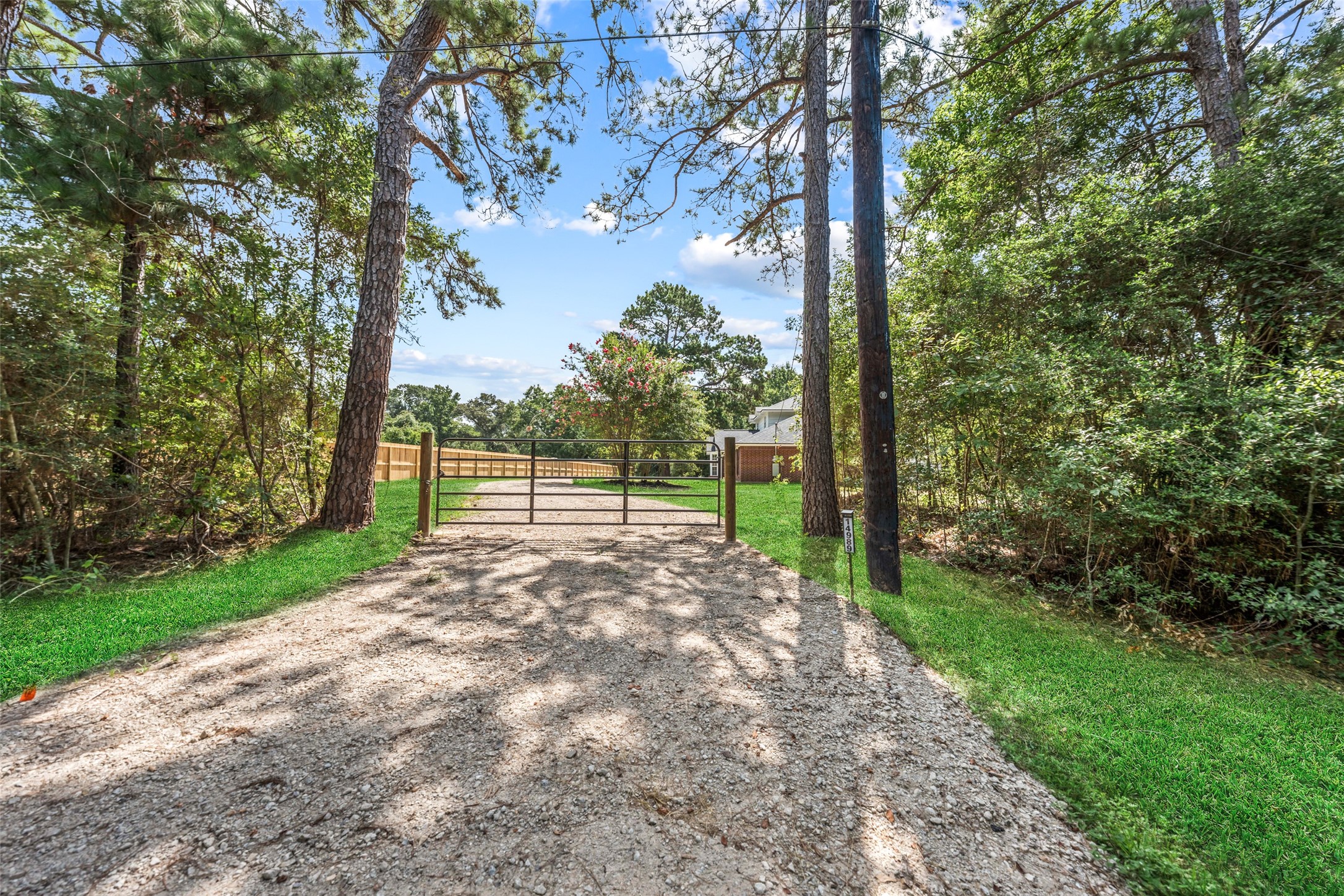 14989 Old Humble Pipeline Road Conroe, TX 77302 - Photo 2 of 33 Driveway gate - notice the privacy fence. *grass has been superimposed*