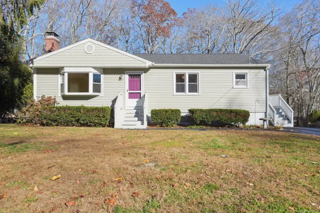 a front view of a house with a yard