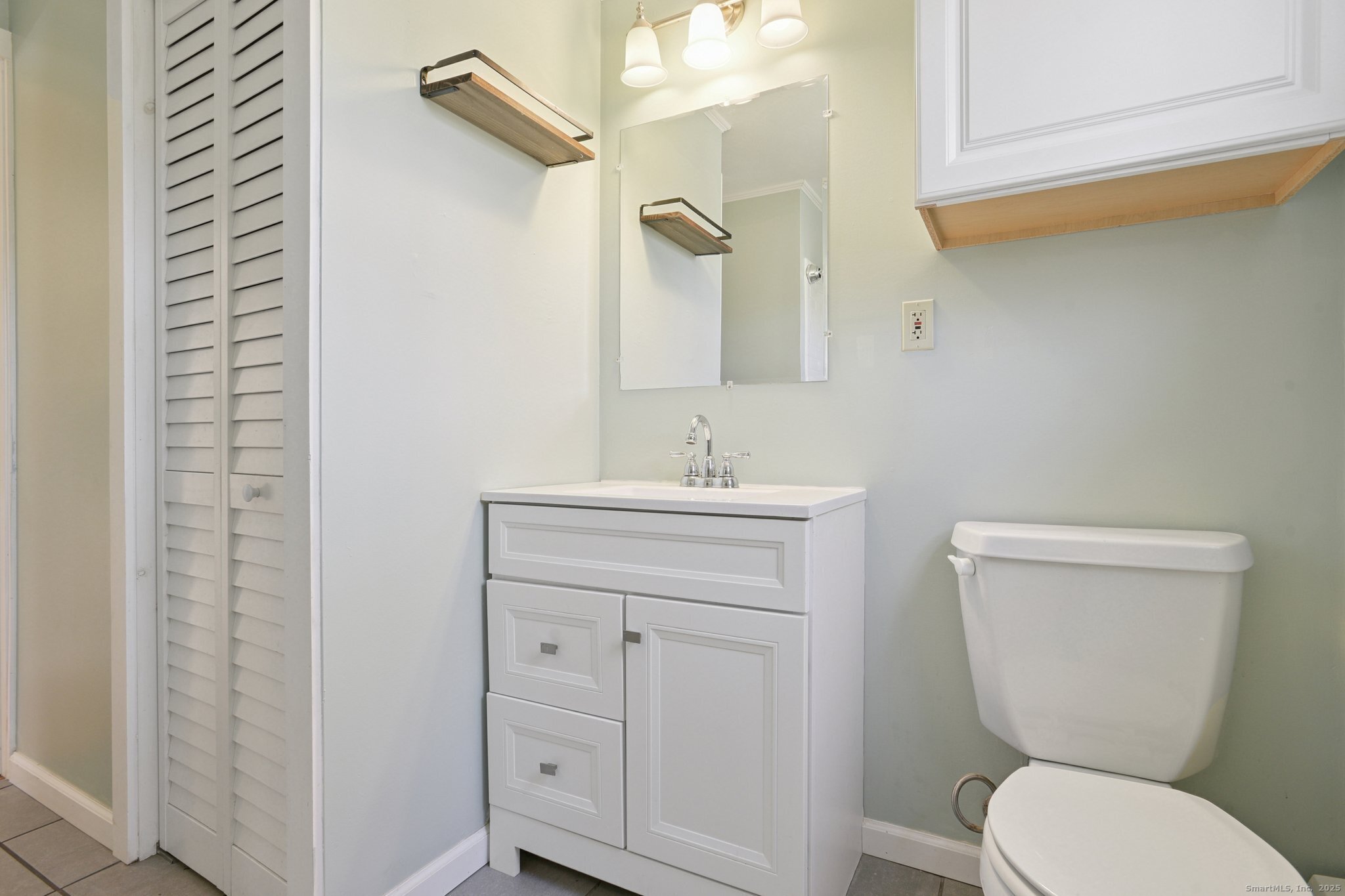 109 Valley Road Groton, CT 06340 - Photo 14 of 28 a bathroom with a toilet sink and mirror