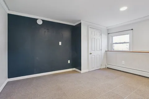 an empty room with windows and closet