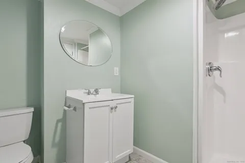 a bathroom with a sink a mirror and a toilet