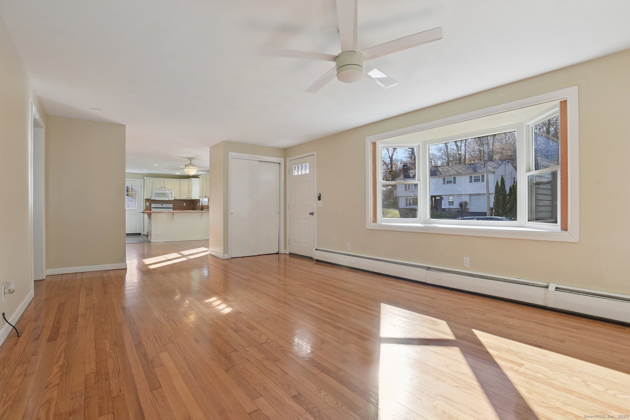 109 Valley Road Groton, CT 06340 - Photo 5 of 28 a view of empty room with wooden floor and windows