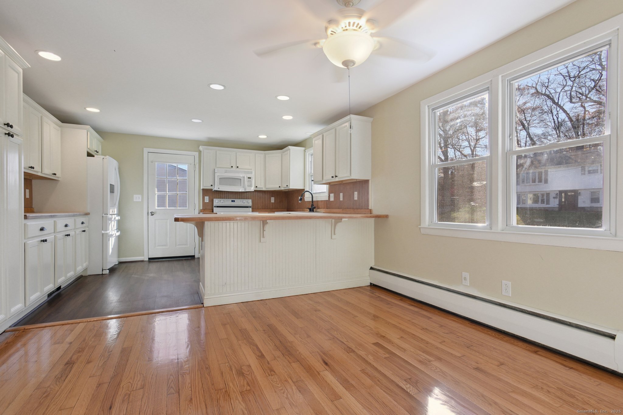 109 Valley Road Groton, CT 06340 - Photo 6 of 28 a kitchen with stainless steel appliances granite countertop a stove top oven a sink dishwasher and a refrigerator with wooden floor