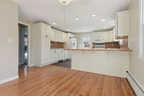 a kitchen with stainless steel appliances a refrigerator sink and microwave