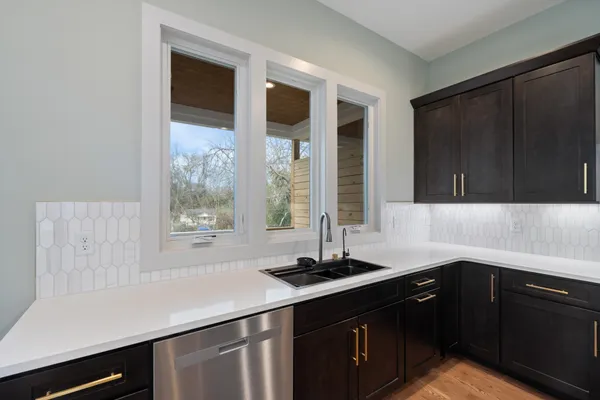 a kitchen with a sink and large window