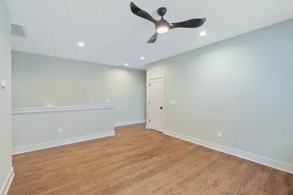 an empty room with a empty space and a ceiling fan