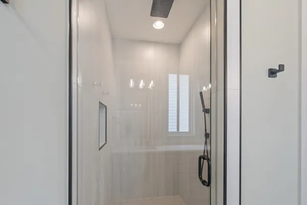 a bathroom with a glass shower door