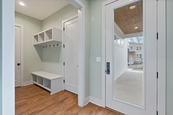 a view of a hallway with wooden floor and entryway