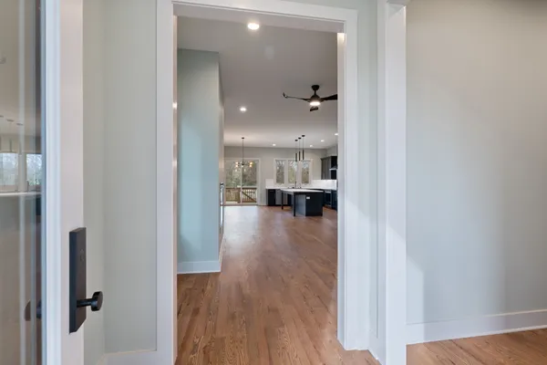 a view of kitchen and hall with wooden floor