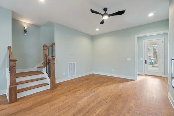 a view of entryway and hall with wooden floor
