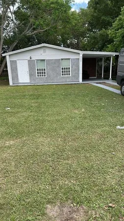 a view of a house with a yard