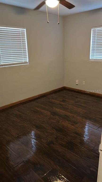 5000 Manduria Street Orlando, FL 32819 - Photo 11 of 17 a view of an empty room with wooden floor and a window