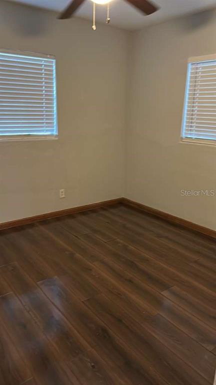 5000 Manduria Street Orlando, FL 32819 - Photo 12 of 17 an empty room with wooden floor and windows