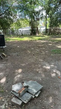 a backyard of water fountain and trees