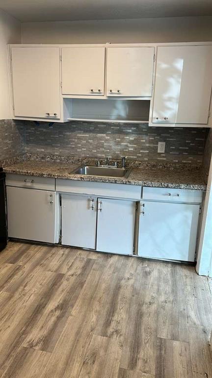 5000 Manduria Street Orlando, FL 32819 - Photo 4 of 17 a kitchen with granite countertop a sink and a stove