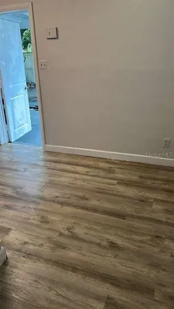 a view of a room with wooden floor