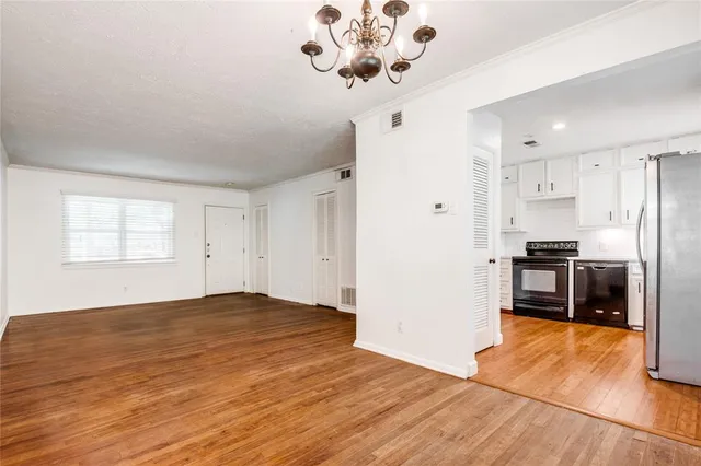 a view of kitchen with a sink a refrigerator and window