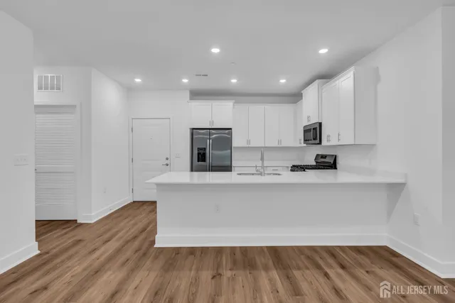 a kitchen with a sink and a stove top oven