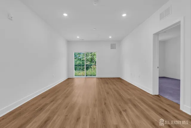 a view of kitchen with wooden floor and electronic appliances