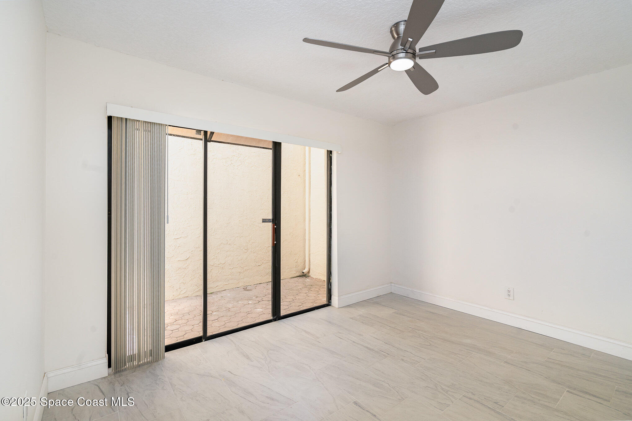 3444 Partridge Court Melbourne, FL 32935 - Photo 15 of 78 an empty room with windows and fan