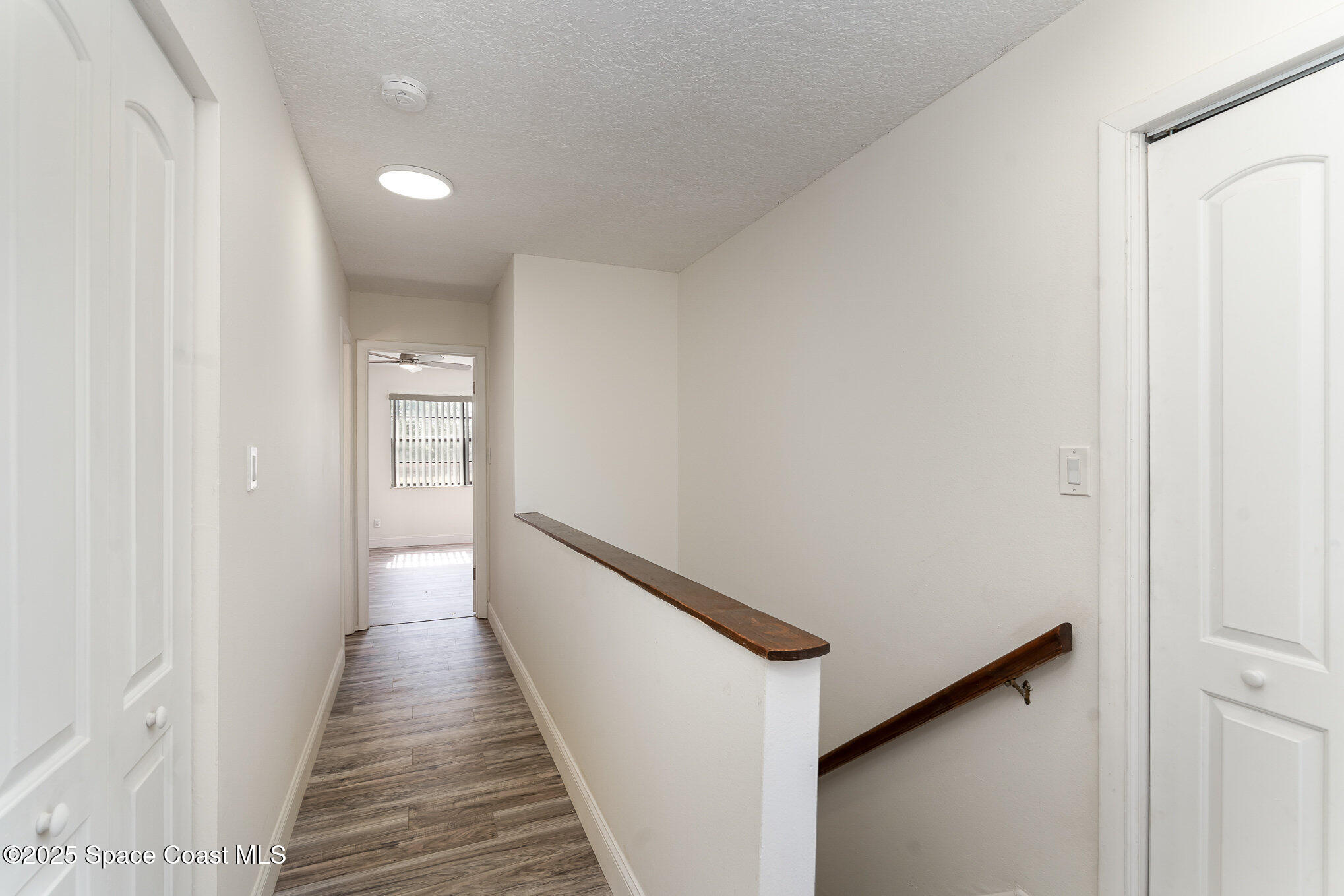 3444 Partridge Court Melbourne, FL 32935 - Photo 17 of 78 a view of a hallway with wooden floor and staircase