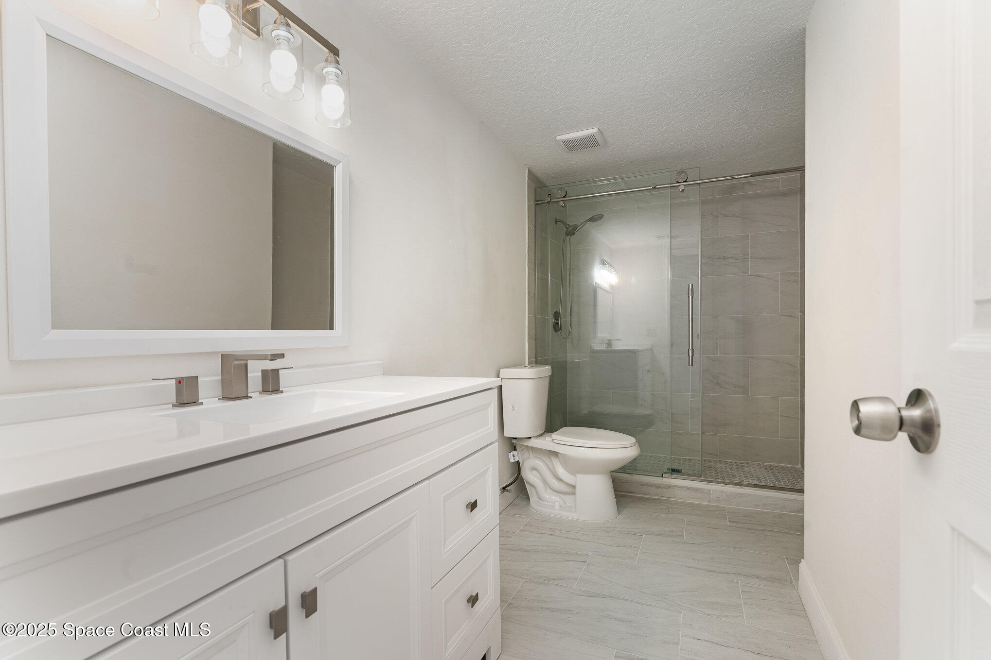 3444 Partridge Court Melbourne, FL 32935 - Photo 20 of 78 a bathroom with a sink a toilet and a mirror