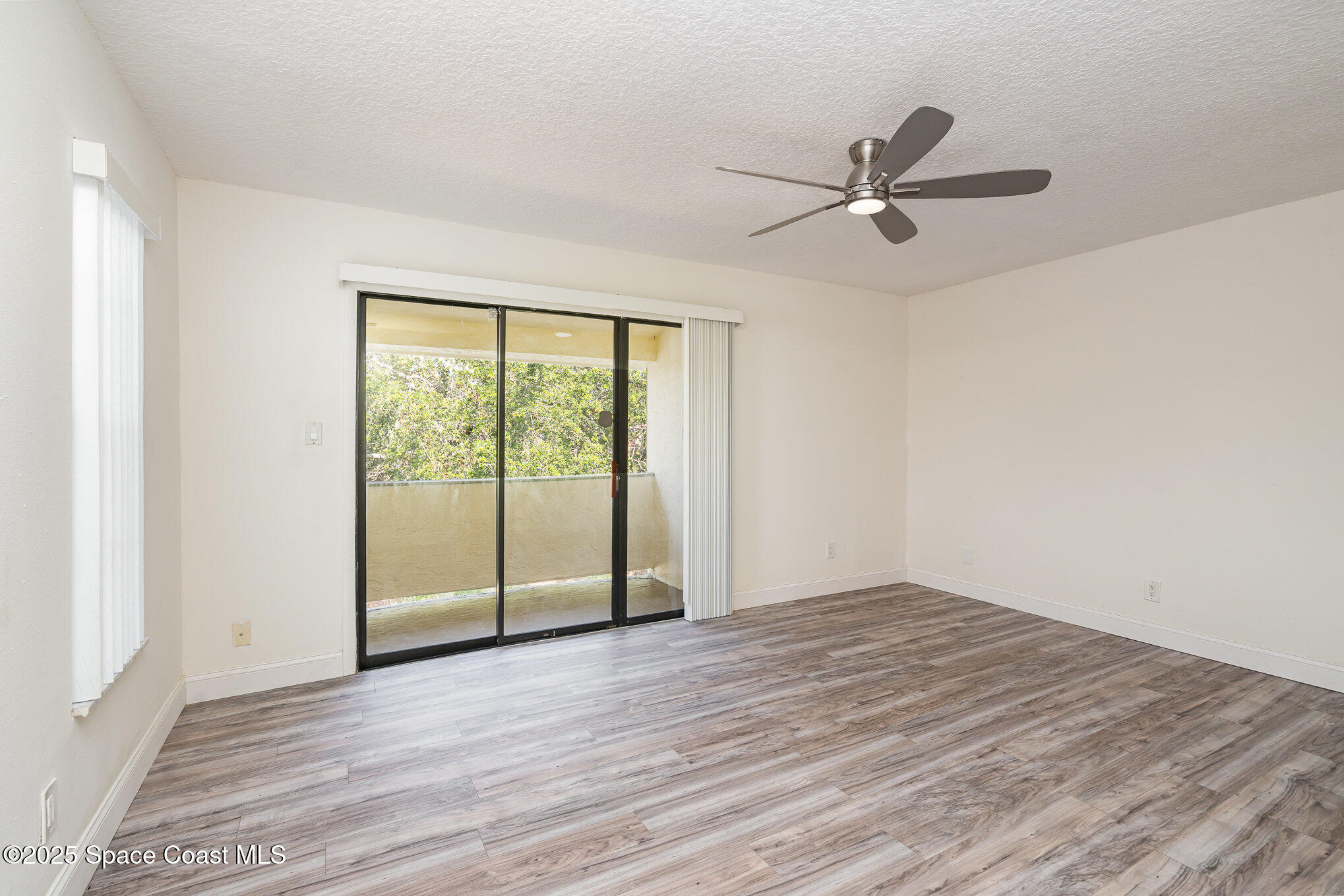 3444 Partridge Court Melbourne, FL 32935 - Photo 21 of 78 a view of empty room with wooden floor and fan