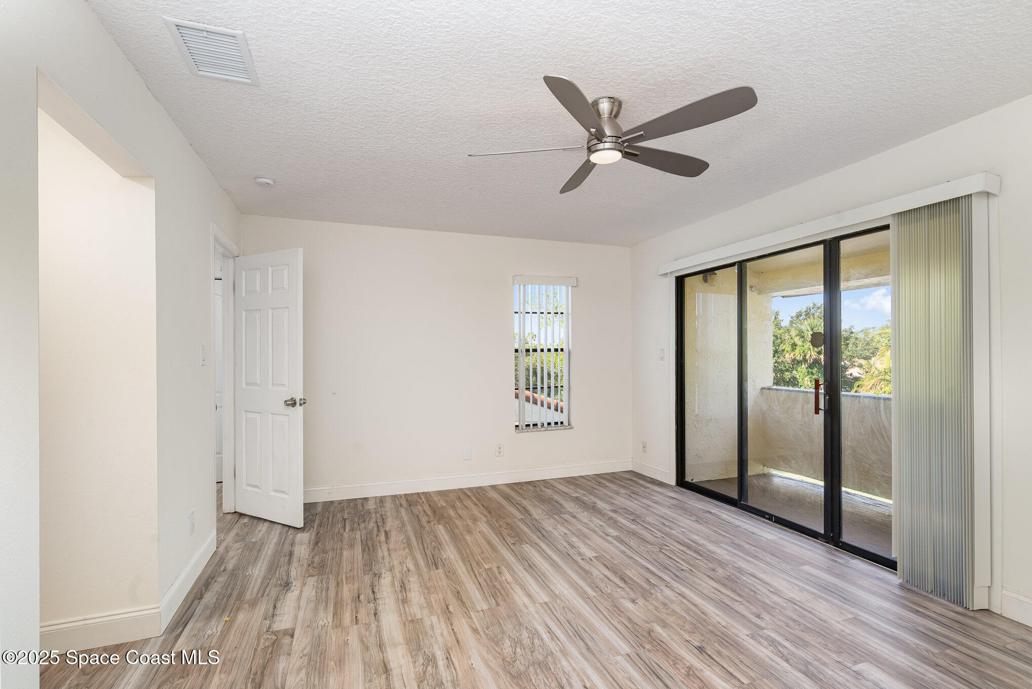 3444 Partridge Court Melbourne, FL 32935 - Photo 23 of 78 a view of empty room with wooden floor and fan